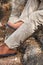 Man wearing brown cargo pants and sitting in the nature park