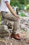 Man wearing brown cargo pants and sitting in the nature park