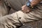 Man wearing brown cargo pants and sitting in the nature park