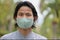 Man wearing a cloth mask in public area protect himself from risk of disease, people prevent infection from coronavirus Covid-19