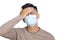 Man wearing face mask feeling sick and got  headache and fever Covid-19 pandemic