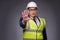 The man wearing hard hat and construction vest