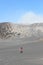 A MAN WEARING HAT AND GUIDE A BIKE IN THE SEA OF SAND