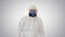 Man wearing hazmat suit walking on gradient background.