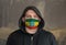 Man Wearing a hood and a Ethiopia flag Mask to Protect him virus