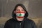 Man Wearing a hood and a Lebanon flag Mask to Protect him virus