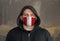 Man Wearing a hood and a Peru flag Mask to Protect him virus