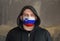 Man Wearing a hood and a Slovenia flag Mask to Protect him virus