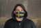 Man Wearing a hood and a Sweden flag Mask to Protect him virus