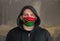 Man Wearing a hood and a Vanuatu flag Mask to Protect him virus