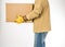 Man wearing jeans and work gloves moving a box