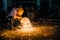 Man wearing mask with his hands grinding in heavy industry