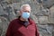 Man wearing a paper mask on his face. A man wears a Medical Face Mask to help avoid contracting Coronavirus aka Covid-19. Covid-19