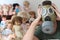 Man wearing pollution mask surrounded by retro dolls