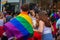 Man wearing pride flag of LGBTQ while celebrating