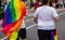 Man wearing pride flag of LGBTQ while celebrating