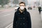 Man wearing protection mask against traffic smog air