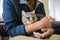 Man wearing protective mask with pet waiting in lobby for medical examination at veterinary clinic. Animal health. Owner