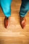 Man wearing shoes on wooden floor. Clothing concept, groom getting ready before ceremony. Body detail of businessman.