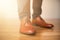 Man wearing shoes on wooden floor. Clothing concept, groom getting ready before ceremony. Body detail of businessman