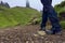 Man wearing trekking boots and gaiters walking to the Old man of Storr