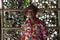 The man wearing a Vietnamese conical hat with a colorful floral pattern shirt