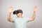 Man wearing virtual reality goggles. Studio shot, gray background.