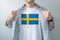 Man wearing white shirt with Sweden flag print