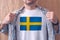 Man wearing white shirt with Sweden flag print