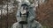 Man wearing a WWII Hazmat suit and gas mask carrying a counter in his hands as he scans for hazardous material in a