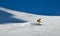 Man wearing yellow suit snowboarding down at extreme double diamond area at Emperial bowl.