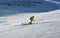 Man wearing yellow suit snowboarding down at extreme double diamond area at Emperial bowl.