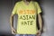 A man wearing yellow T-shirt with Stop Asian Hate text