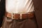 Man wears belt. Close-up of male waist on brown leather belt