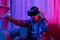 Man wears virtual reality glasses and uses joystick to play games with fun