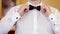 Man wears white shirt and bow tie