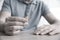 Man with wedding ring at table indoors, closeup. Cheating and breakup