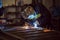 Man welding creating sparks, wearing safety equipment