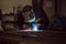 Man welding creating sparks, wearing safety equipment