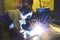 Man welding metal tank