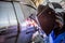 Man welding with reflection of sparks on visor