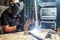 Man welds a metal arc welding machine