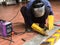 A man welds a metal with a welding job