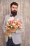 Man well groomed wear tuxedo bow tie hold flowers bouquet. Invite her dating. Romantic man with flowers. Romantic gift