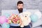 Man well groomed wear tuxedo bow tie hold flowers tulips bouquet and big teddy bear toy. Invite her dating. Romantic