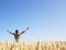 Man in Wheat Field With Arms Outstretched