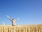 Man in Wheat Field With Arms Outstretched