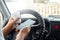 A man at the wheel holding a smartphone in his hand, violates traffic rules. The concept of an accident, a traffic violation, the