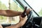 A man at the wheel holds a bottle of alcohol in his hand while driving, violates traffic rules. The concept of an accident, a