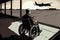 man in wheelchair, boarding airplane, with view of the runway and airport